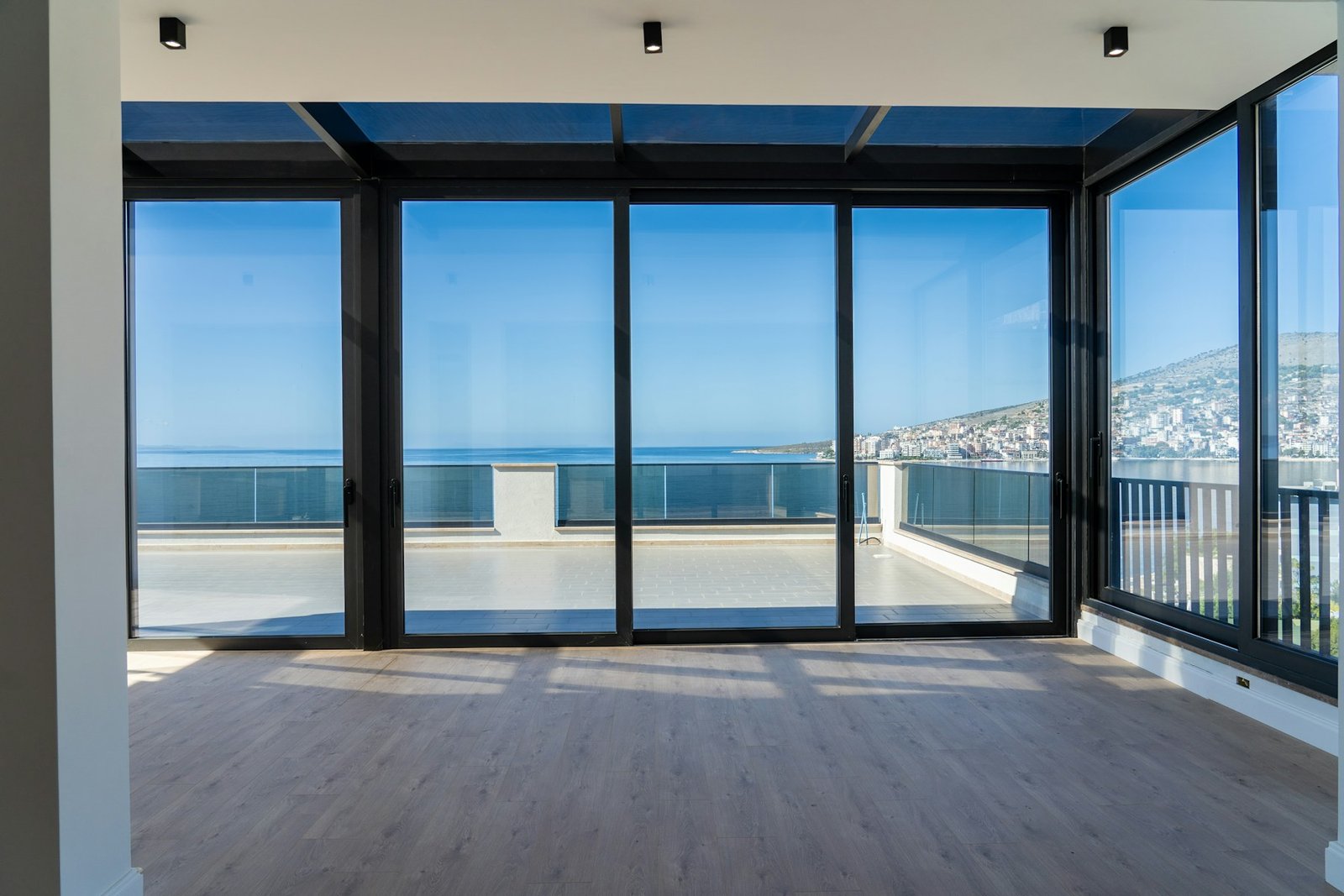 Soft light through panoramic glazing in a waterfront residence